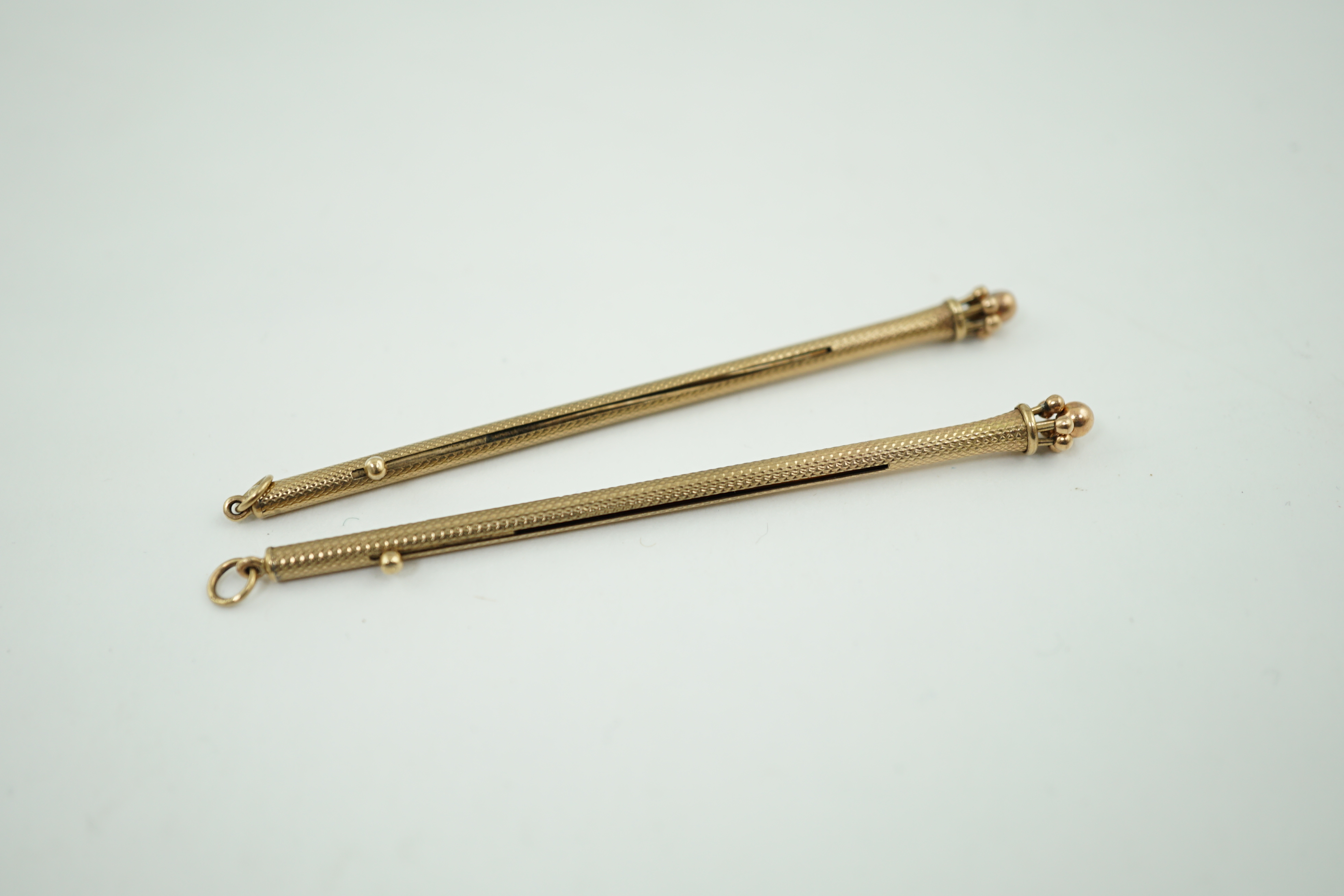 A pair of George V engine turned 9ct gold swizzle sticks, by Sampson Mordan & Co, London, 1934